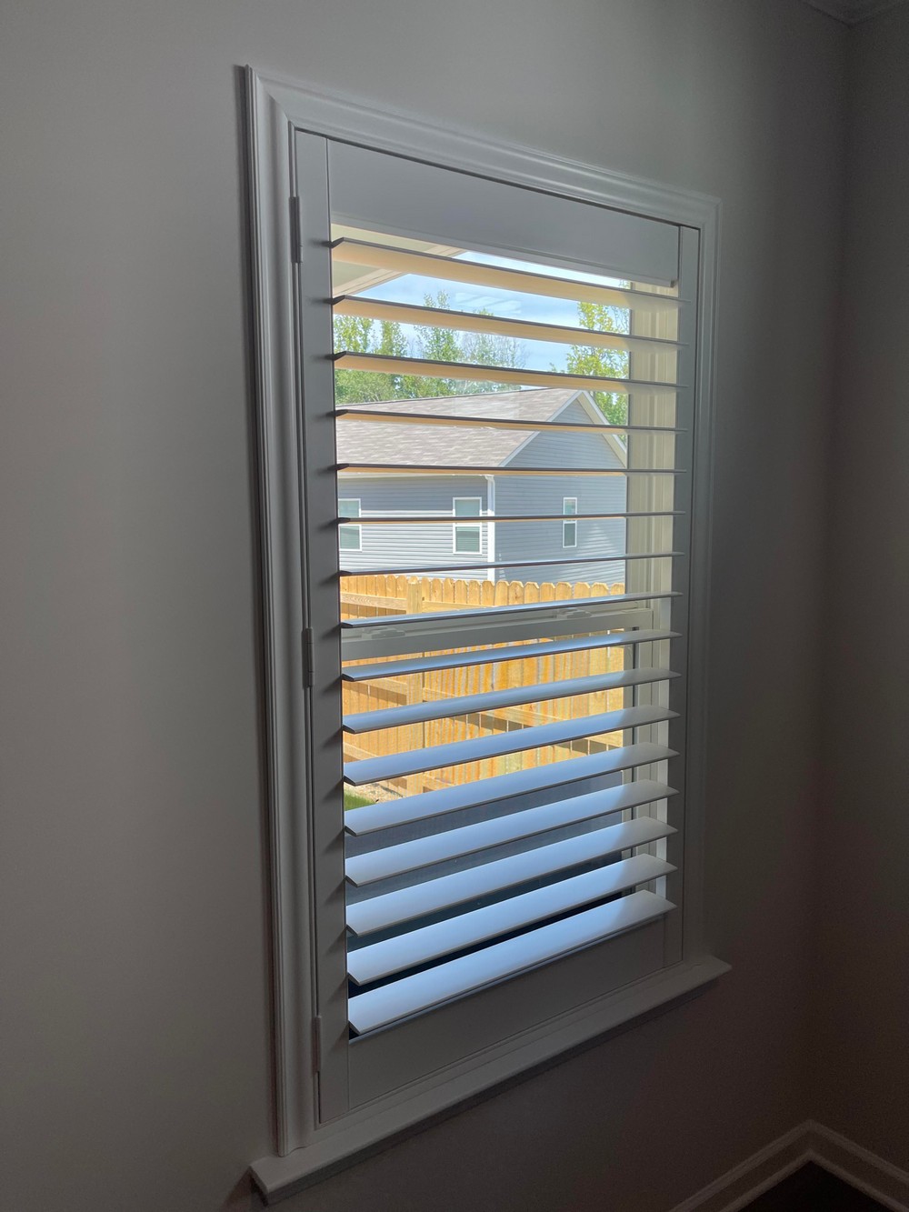 Elegant Composite Shutters with Hidden Tilt and Norman Roller Shades at Wilora Pond in Charlotte, NC